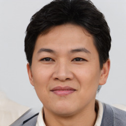 Joyful asian young-adult male with short  brown hair and brown eyes