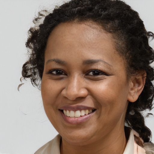 Joyful black young-adult female with medium  brown hair and brown eyes