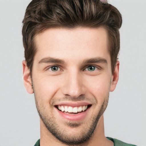 Joyful white young-adult male with short  brown hair and grey eyes