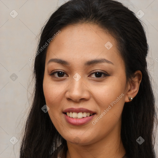 Joyful latino young-adult female with long  brown hair and brown eyes