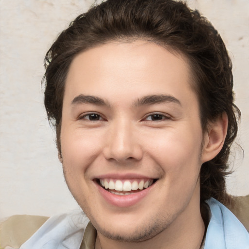 Joyful white young-adult male with medium  brown hair and brown eyes