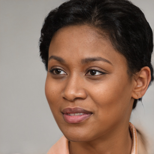 Joyful latino young-adult female with short  brown hair and brown eyes