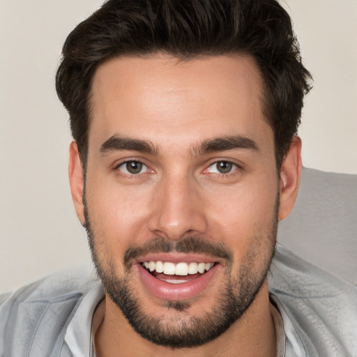 Joyful white young-adult male with short  brown hair and brown eyes