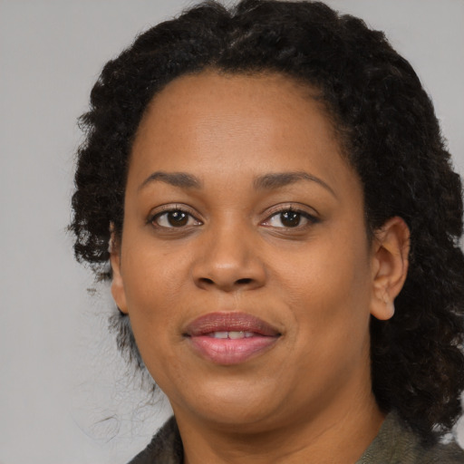 Joyful black adult female with medium  black hair and brown eyes