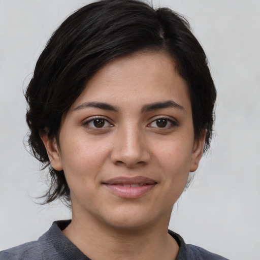 Joyful white young-adult female with medium  black hair and brown eyes