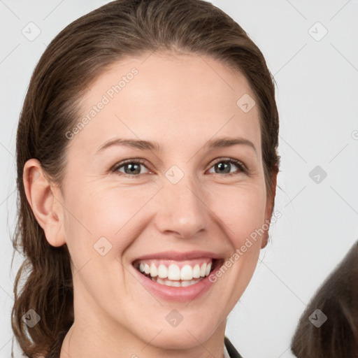 Joyful white young-adult female with long  brown hair and grey eyes