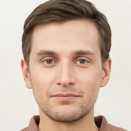 Joyful white young-adult male with short  brown hair and grey eyes