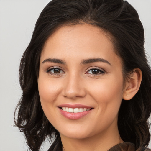 Joyful white young-adult female with long  brown hair and brown eyes