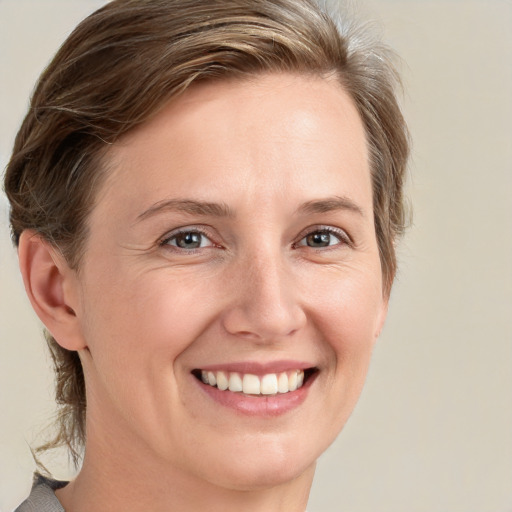 Joyful white adult female with medium  brown hair and brown eyes