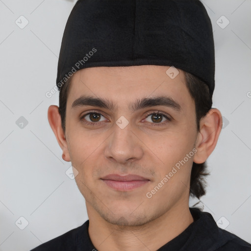 Joyful white young-adult male with short  black hair and brown eyes