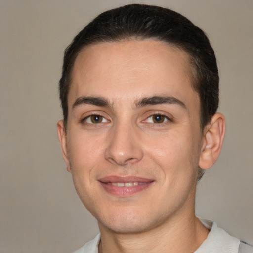 Joyful white young-adult male with short  brown hair and brown eyes