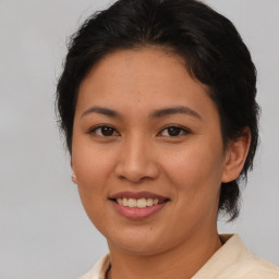 Joyful asian young-adult female with short  brown hair and brown eyes