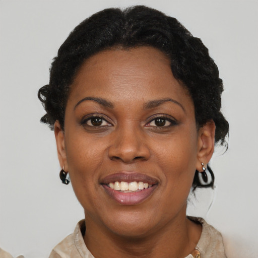 Joyful black adult female with short  brown hair and brown eyes