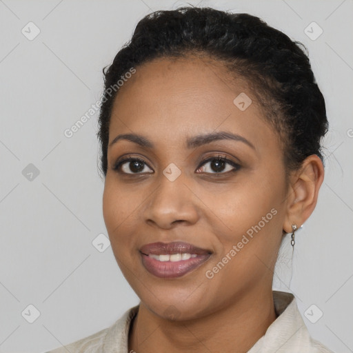 Joyful black young-adult female with short  black hair and brown eyes