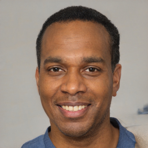 Joyful latino adult male with short  black hair and brown eyes