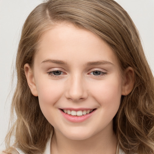 Joyful white child female with long  brown hair and brown eyes