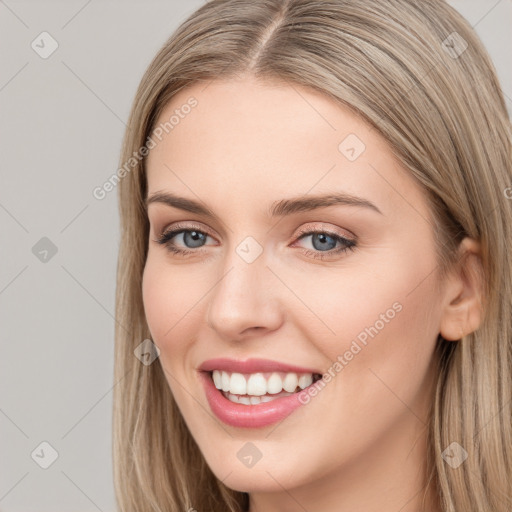 Joyful white young-adult female with long  brown hair and blue eyes