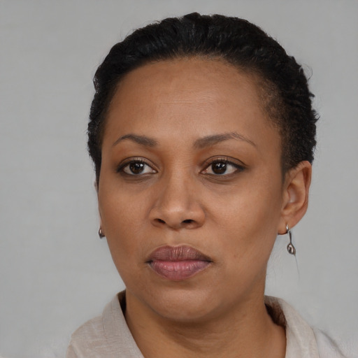 Joyful black adult female with short  black hair and brown eyes