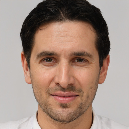 Joyful white adult male with short  brown hair and brown eyes