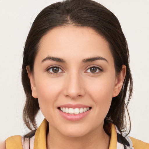 Joyful white young-adult female with medium  brown hair and brown eyes