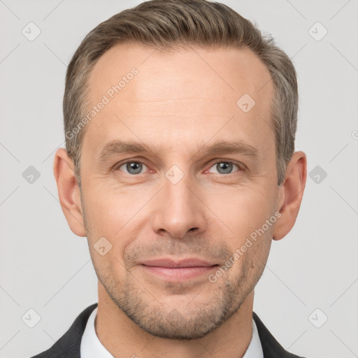 Joyful white adult male with short  brown hair and grey eyes