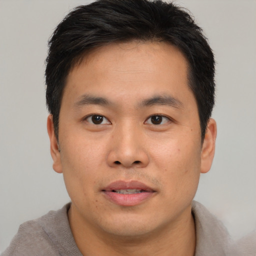 Neutral asian young-adult male with short  brown hair and brown eyes