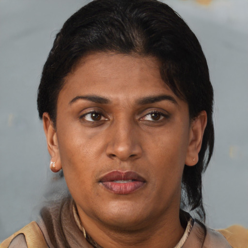Joyful black adult female with short  brown hair and brown eyes