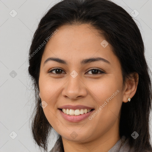 Joyful latino young-adult female with long  brown hair and brown eyes