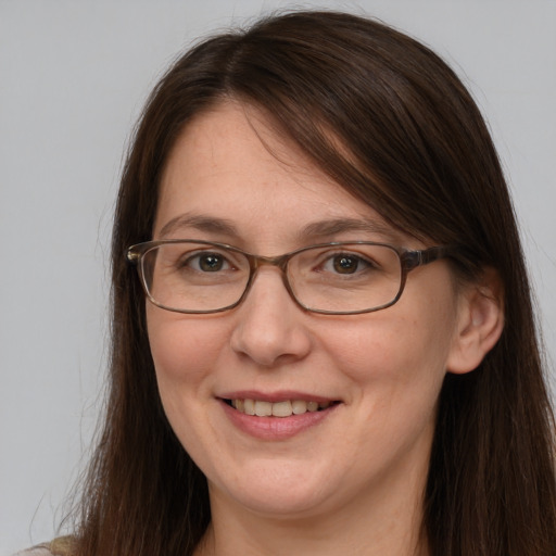 Joyful white adult female with long  brown hair and grey eyes