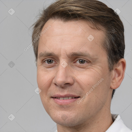 Joyful white adult male with short  brown hair and brown eyes