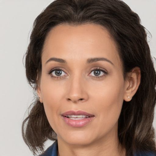 Joyful white adult female with medium  brown hair and brown eyes