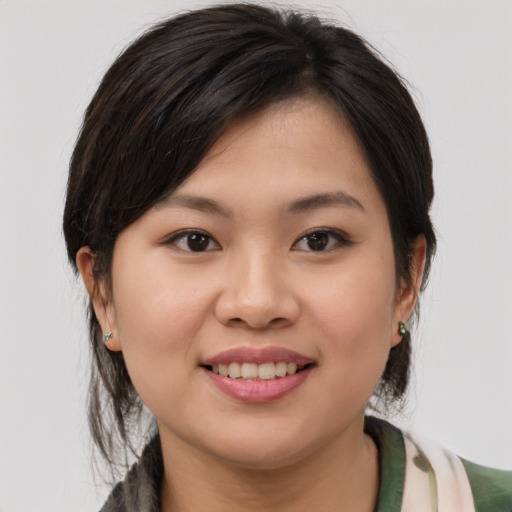 Joyful white young-adult female with medium  brown hair and brown eyes
