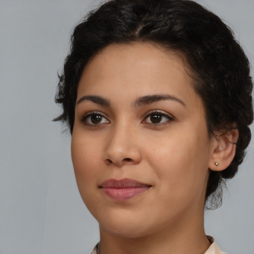 Joyful latino young-adult female with medium  black hair and brown eyes