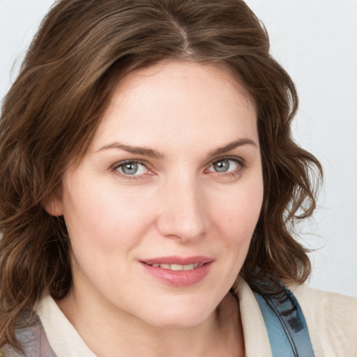 Joyful white young-adult female with medium  brown hair and blue eyes