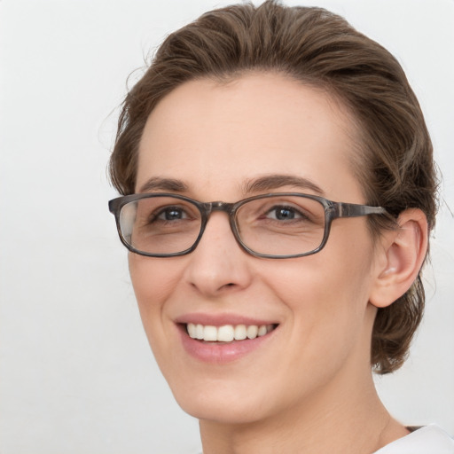 Joyful white young-adult female with medium  brown hair and green eyes