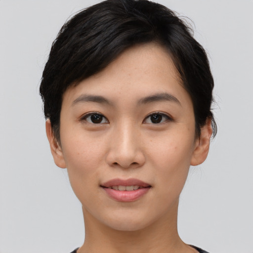 Joyful asian young-adult female with short  black hair and brown eyes