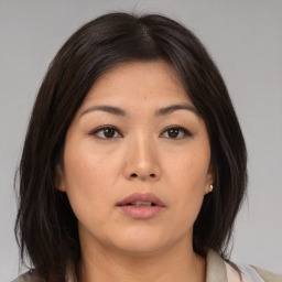 Neutral asian young-adult female with medium  brown hair and brown eyes