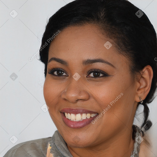 Joyful black young-adult female with medium  black hair and brown eyes