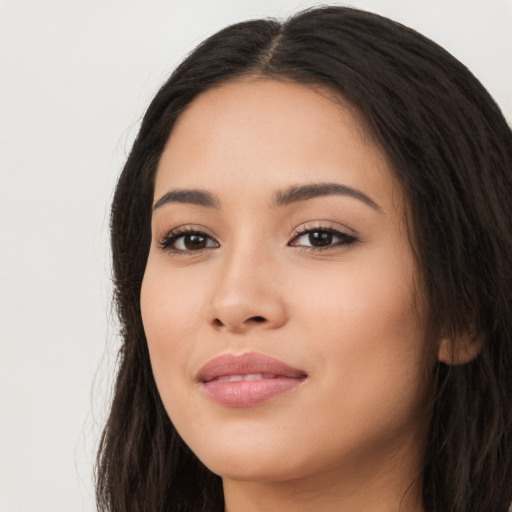 Joyful latino young-adult female with long  black hair and brown eyes