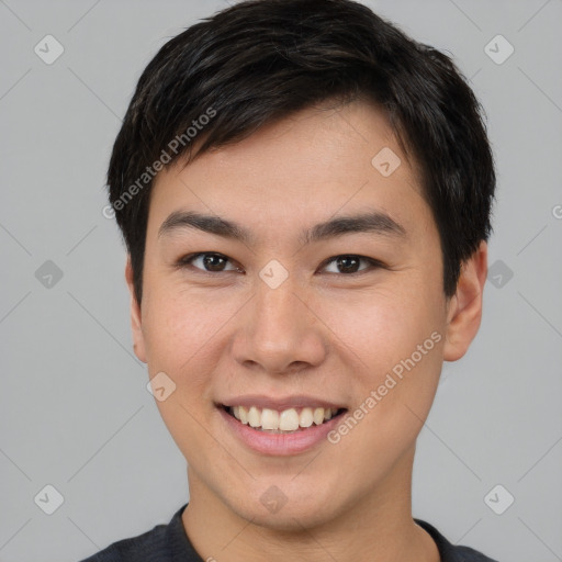 Joyful asian young-adult male with short  brown hair and brown eyes