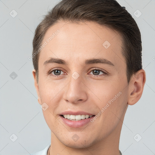 Joyful white young-adult female with short  brown hair and brown eyes