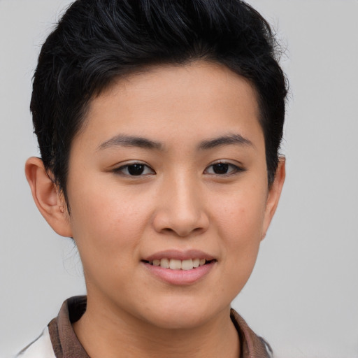 Joyful asian young-adult female with short  brown hair and brown eyes