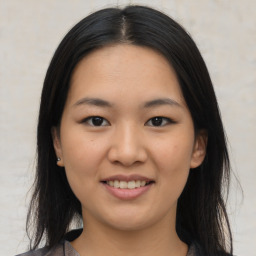 Joyful asian young-adult female with medium  brown hair and brown eyes