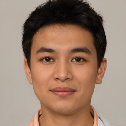 Joyful latino young-adult male with short  brown hair and brown eyes