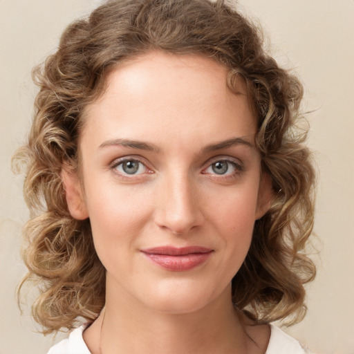 Joyful white young-adult female with medium  brown hair and green eyes