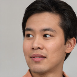 Joyful asian young-adult male with short  brown hair and brown eyes