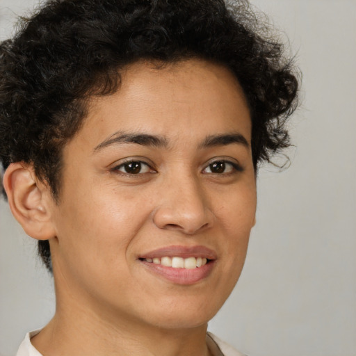 Joyful latino young-adult female with short  brown hair and brown eyes