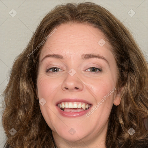 Joyful white adult female with long  brown hair and green eyes