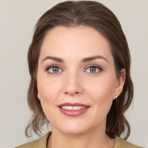 Joyful white young-adult female with medium  brown hair and brown eyes