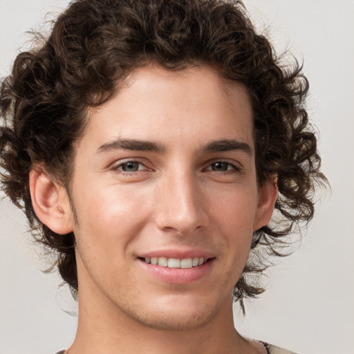 Joyful white young-adult male with medium  brown hair and brown eyes